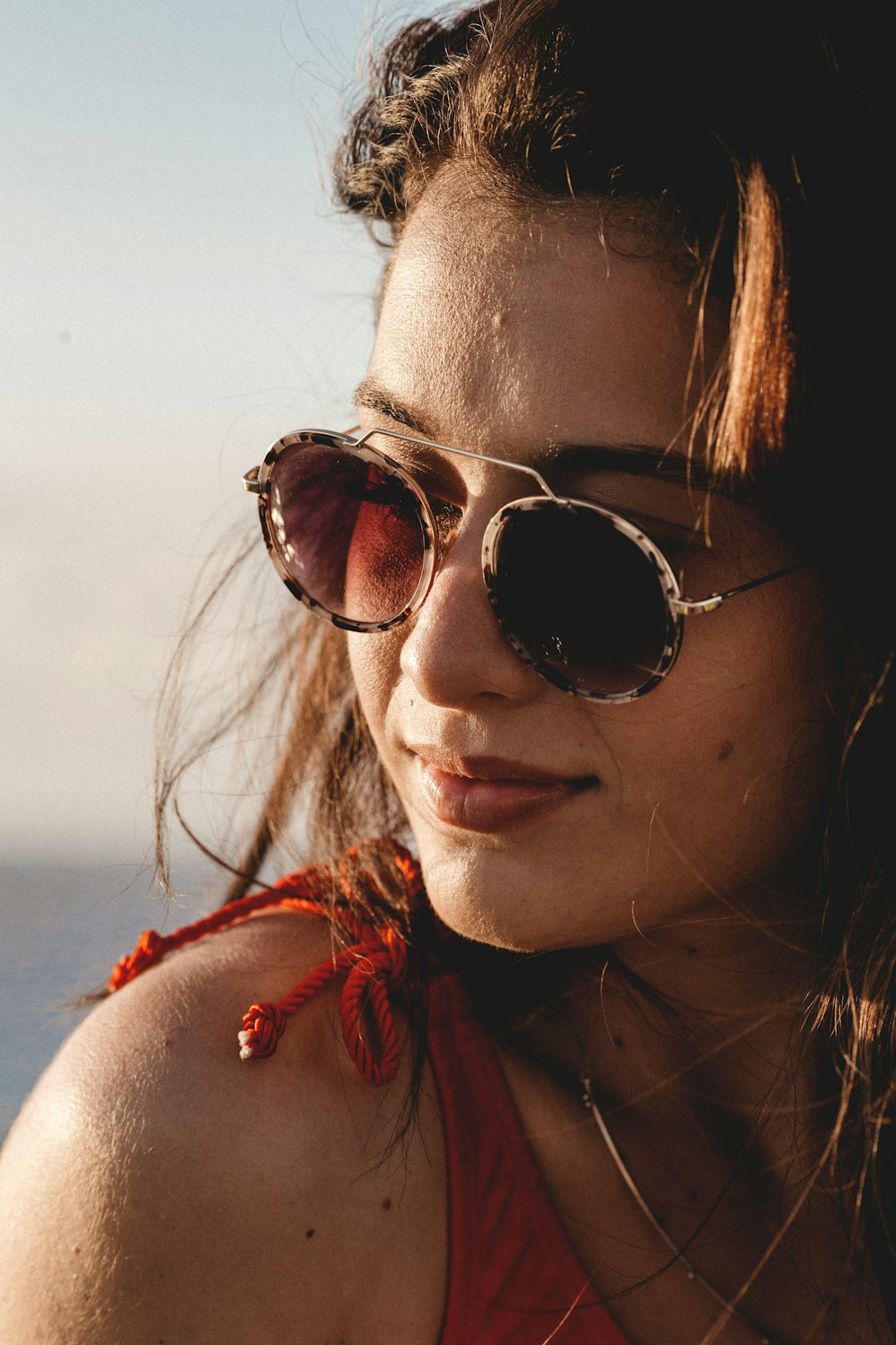 woman in red shirt wearing black sunglasses