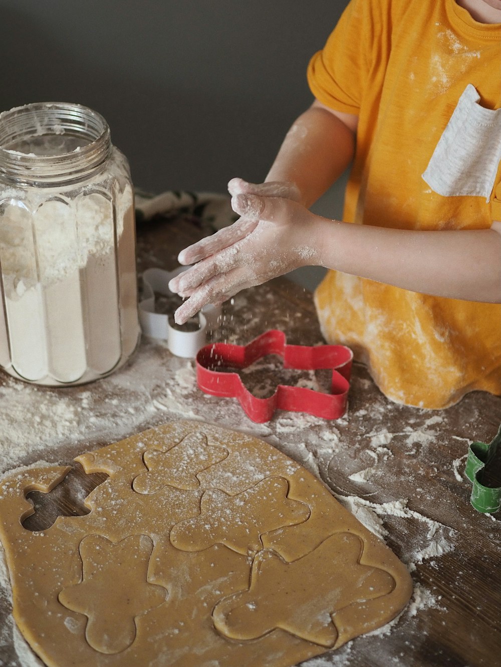 person holding clear glass jar with white powder