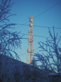 brown electric post under blue sky during daytime