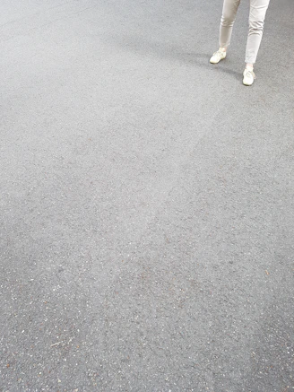 A pair of clean, simple tapered joggers laid out on a neutral surface.