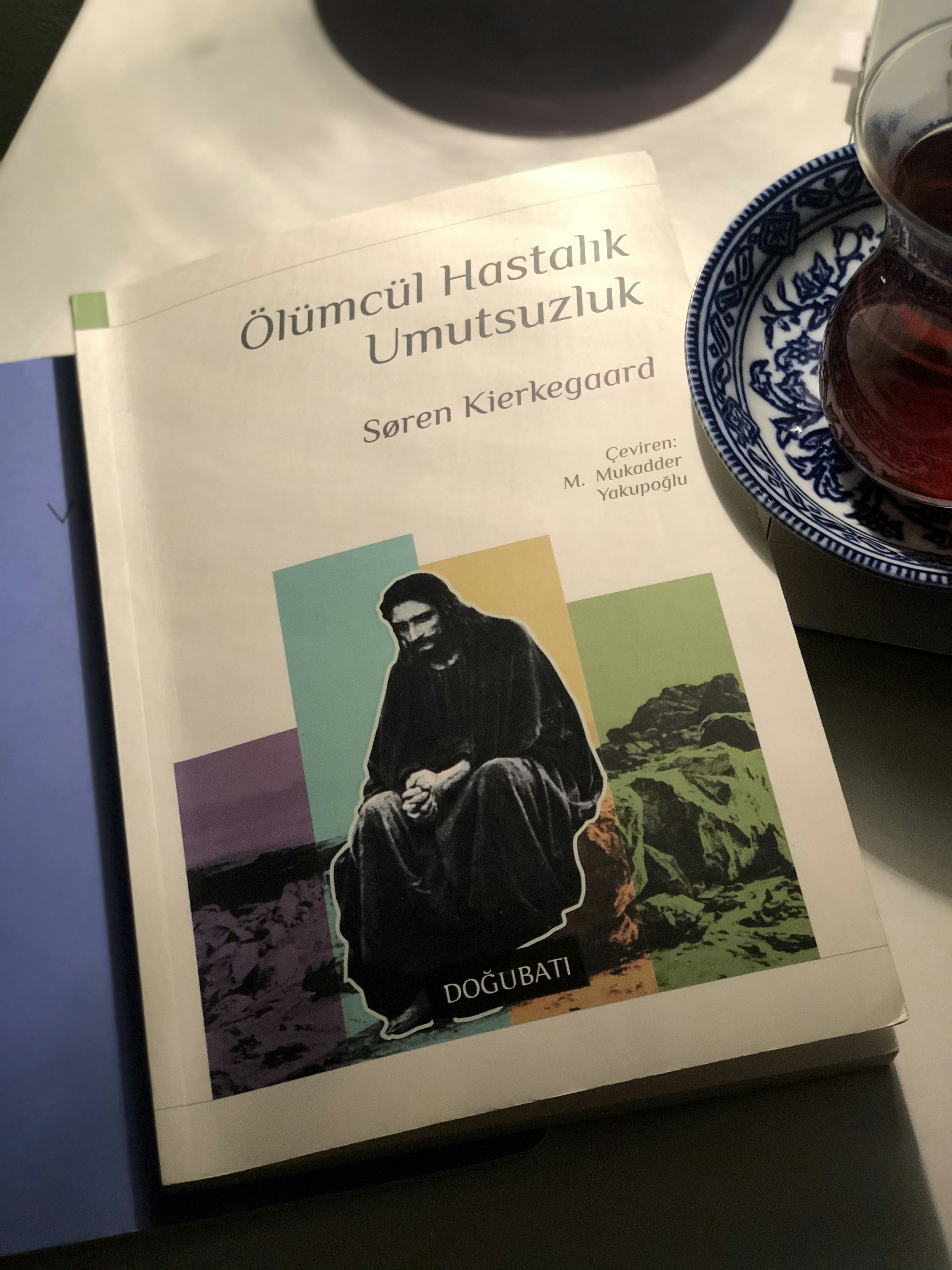 a cup of tea and a book on a table