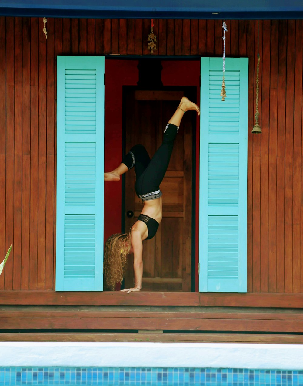 woman in black shirt and black shorts bending her body