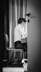 woman in white sweater sitting on chair