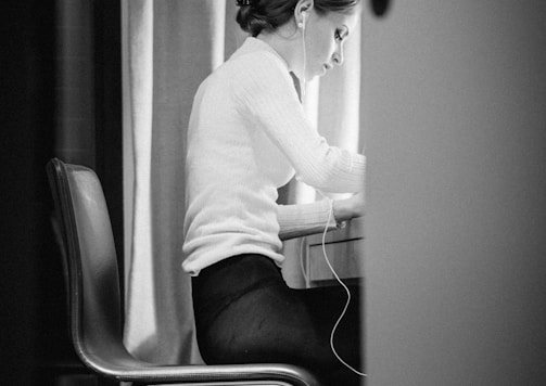 woman in white sweater sitting on chair