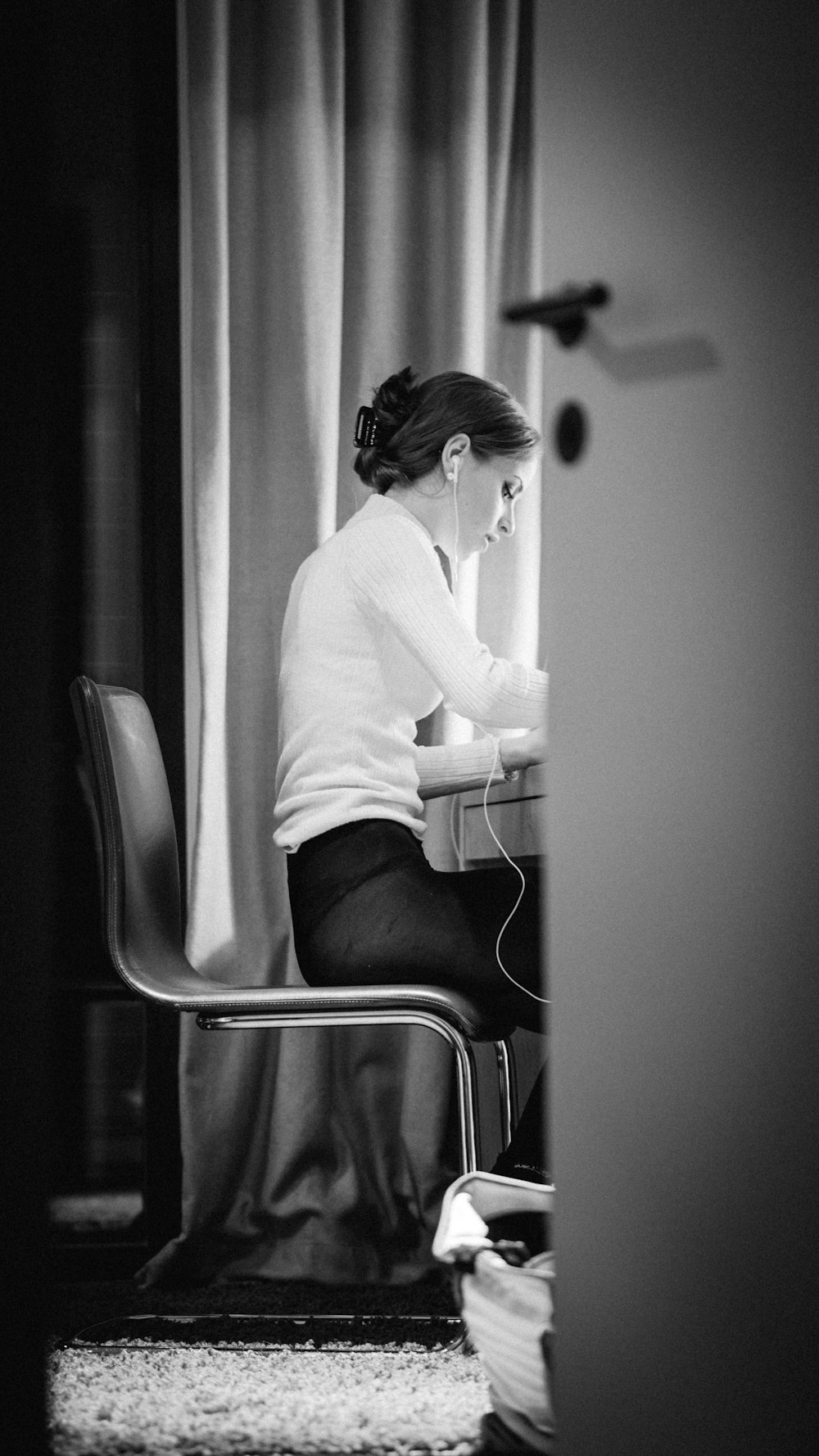 woman in white sweater sitting on chair