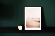 An elegant picture frame showcasing a vibrant landscape photo on a cozy shelf.