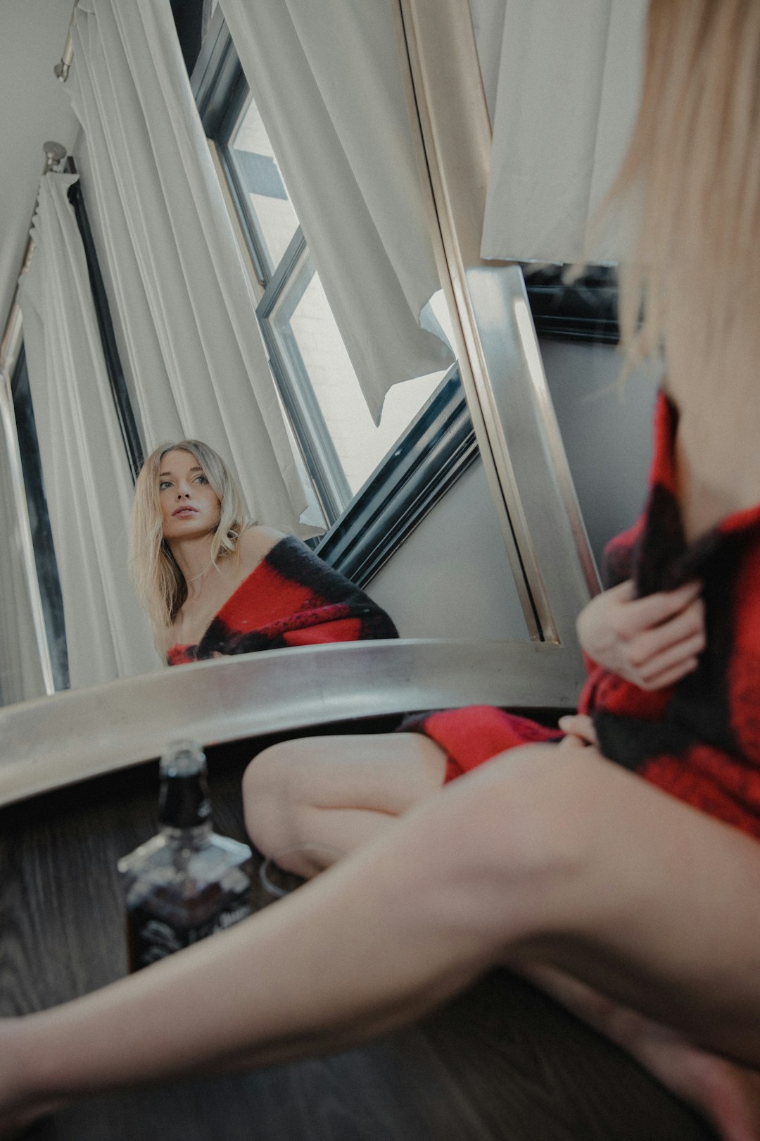 woman in red sleeveless dress sitting on chair