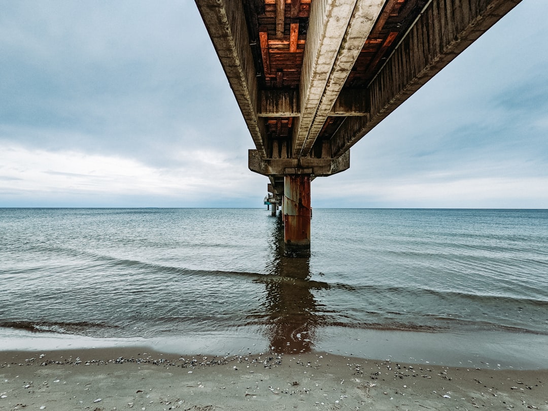 brown wooden bridge over the sea during daytime