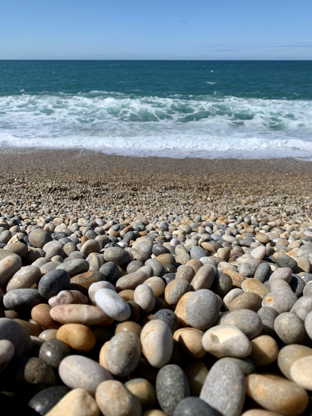 brown and gray stones on beach during daytime