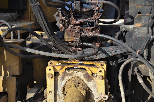 Technician inspecting hydraulic components of a marine surface drive system.