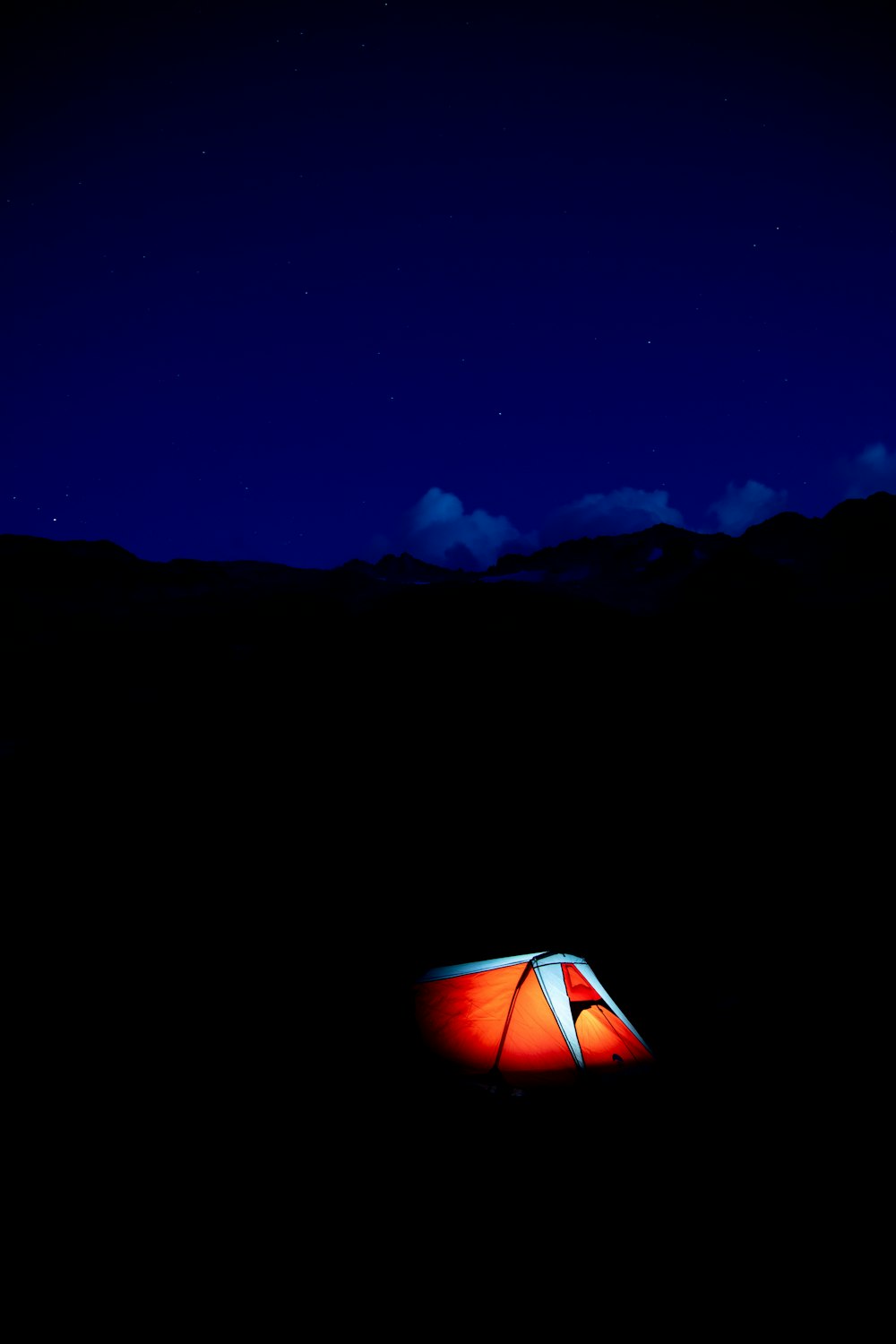 white and red tent on mountain during night time