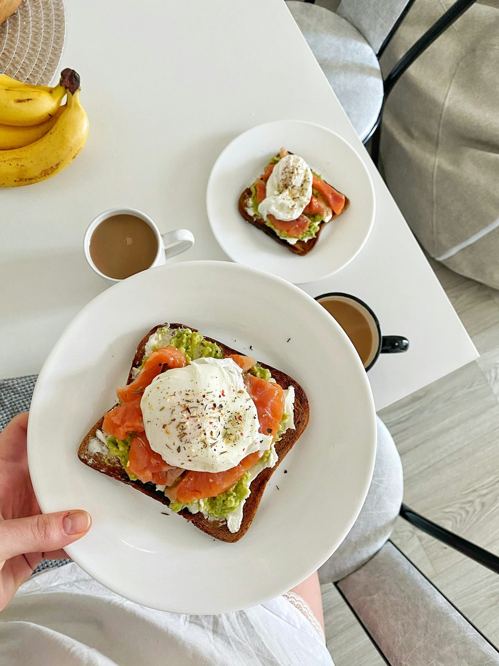 person holding white ceramic plate with food