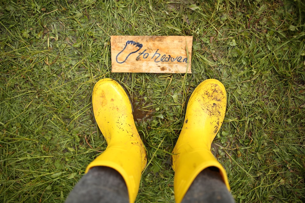 yellow rain boots on green grass