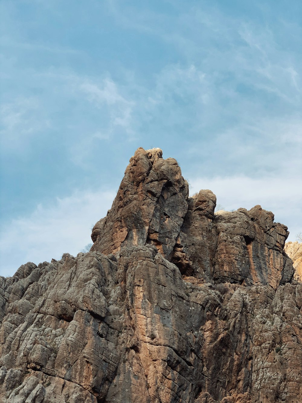 brown rock formation under blue sky during daytime