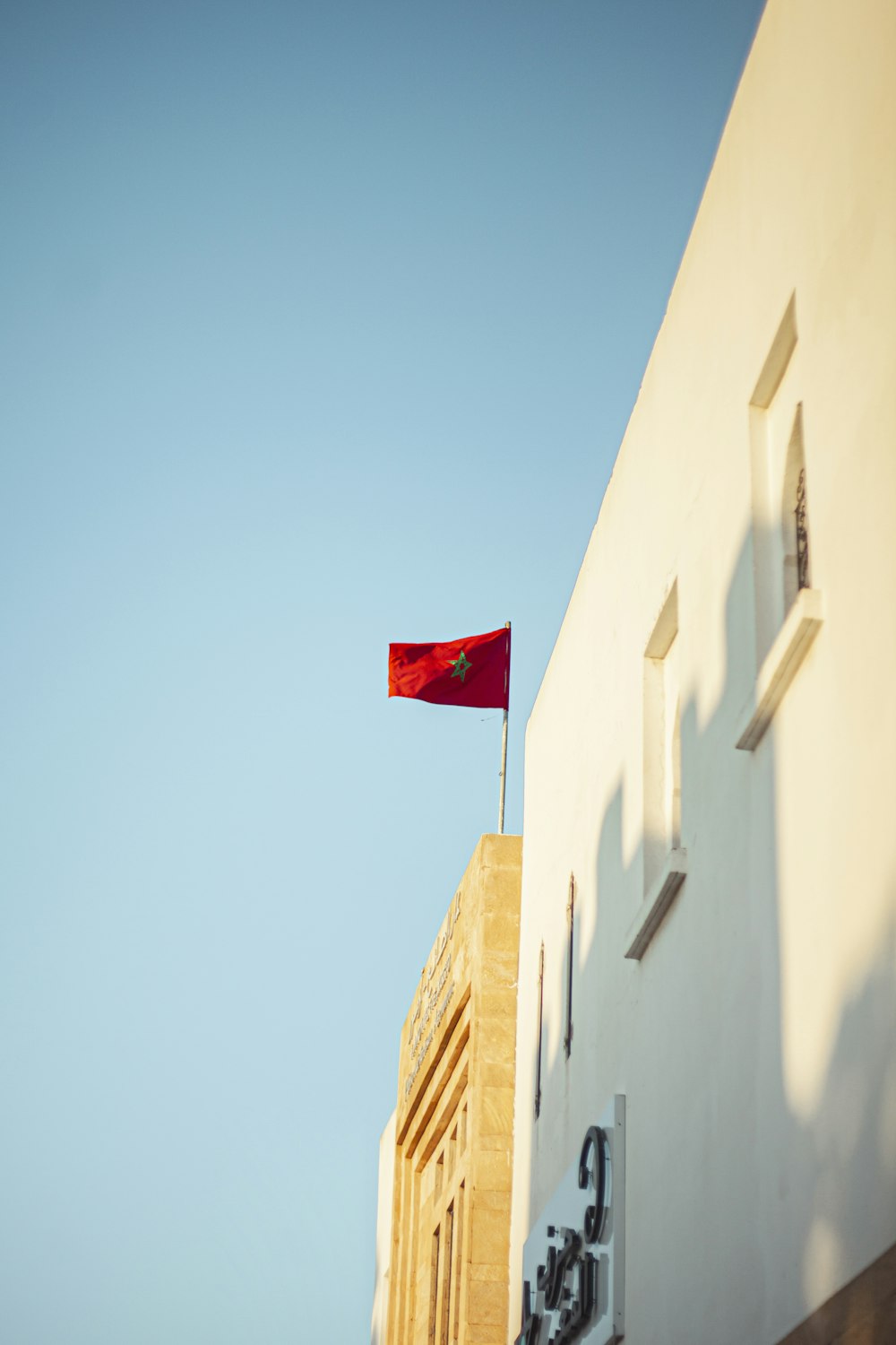red and white flag on brown concrete building