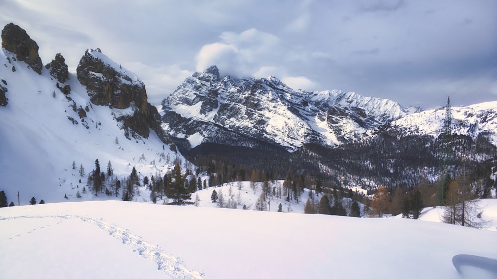 snow covered mountain under cloudy sky during daytime