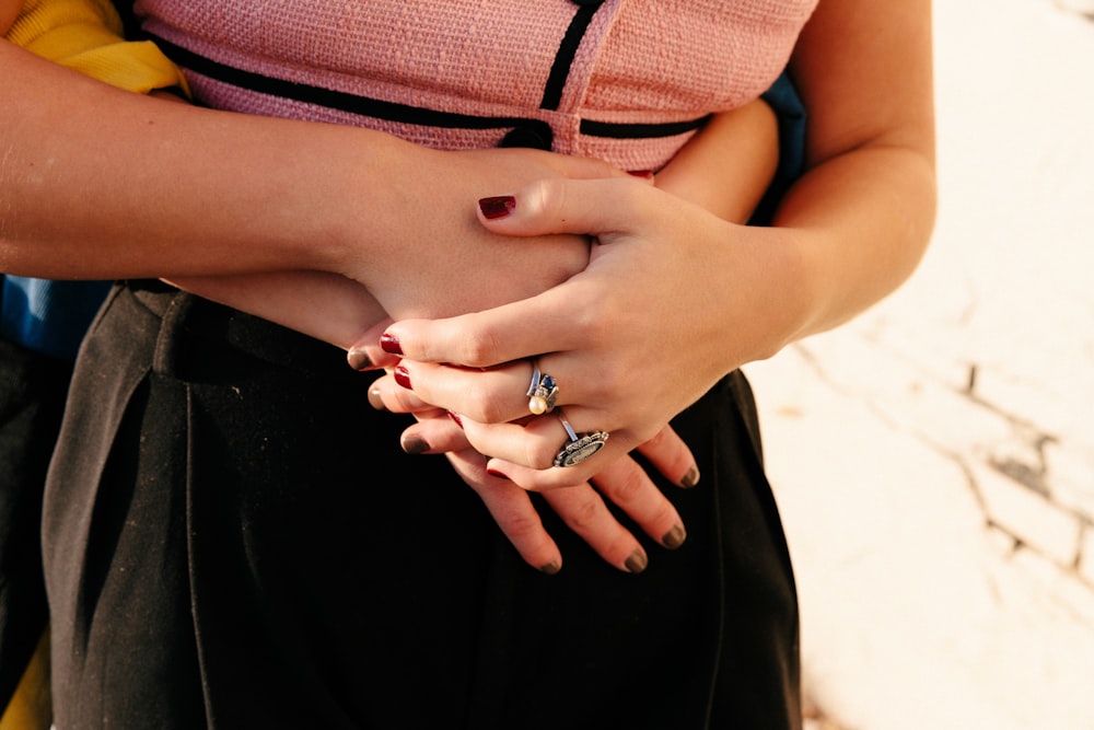 woman wearing silver ring and black skirt