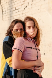 woman in blue and yellow dress carrying girl in brown woven basket