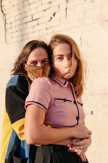 woman in blue and yellow dress carrying girl in brown woven basket
