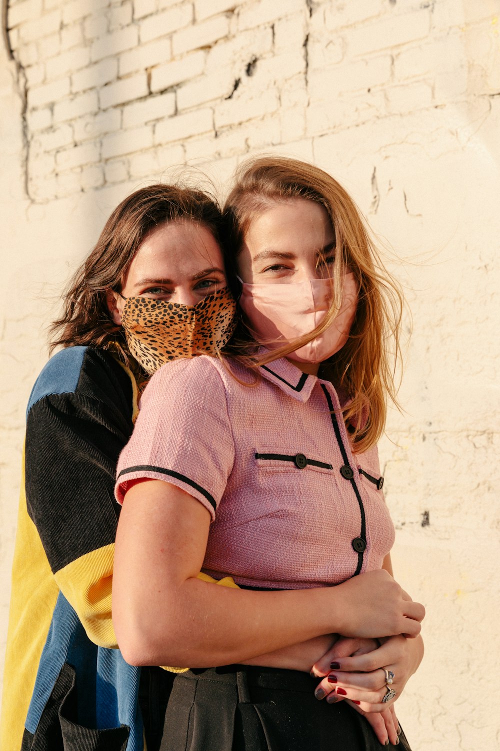 woman in blue and yellow dress carrying girl in brown woven basket