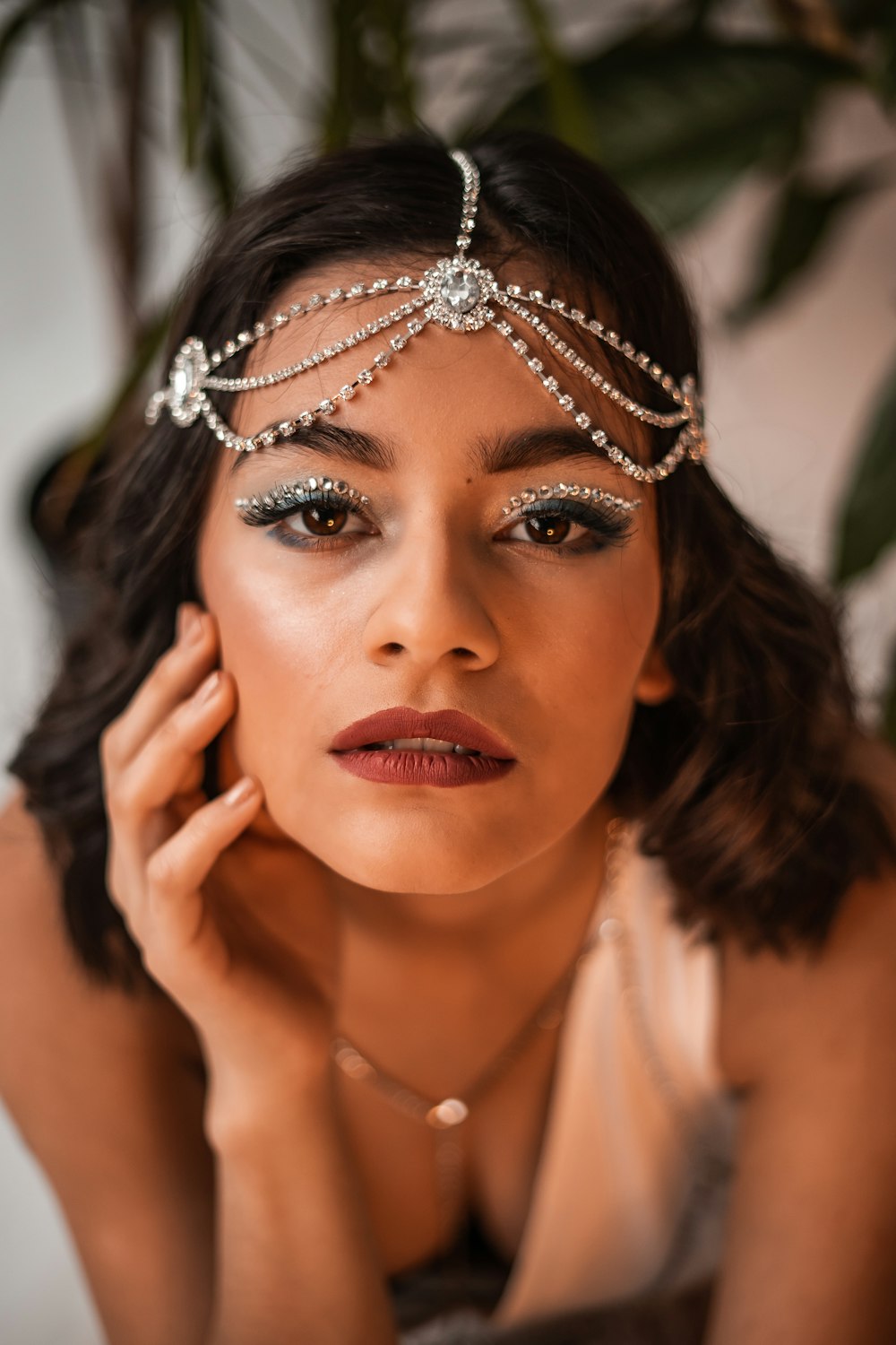 woman in white sleeveless top wearing silver tiara