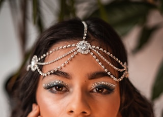 woman in white sleeveless top wearing silver tiara