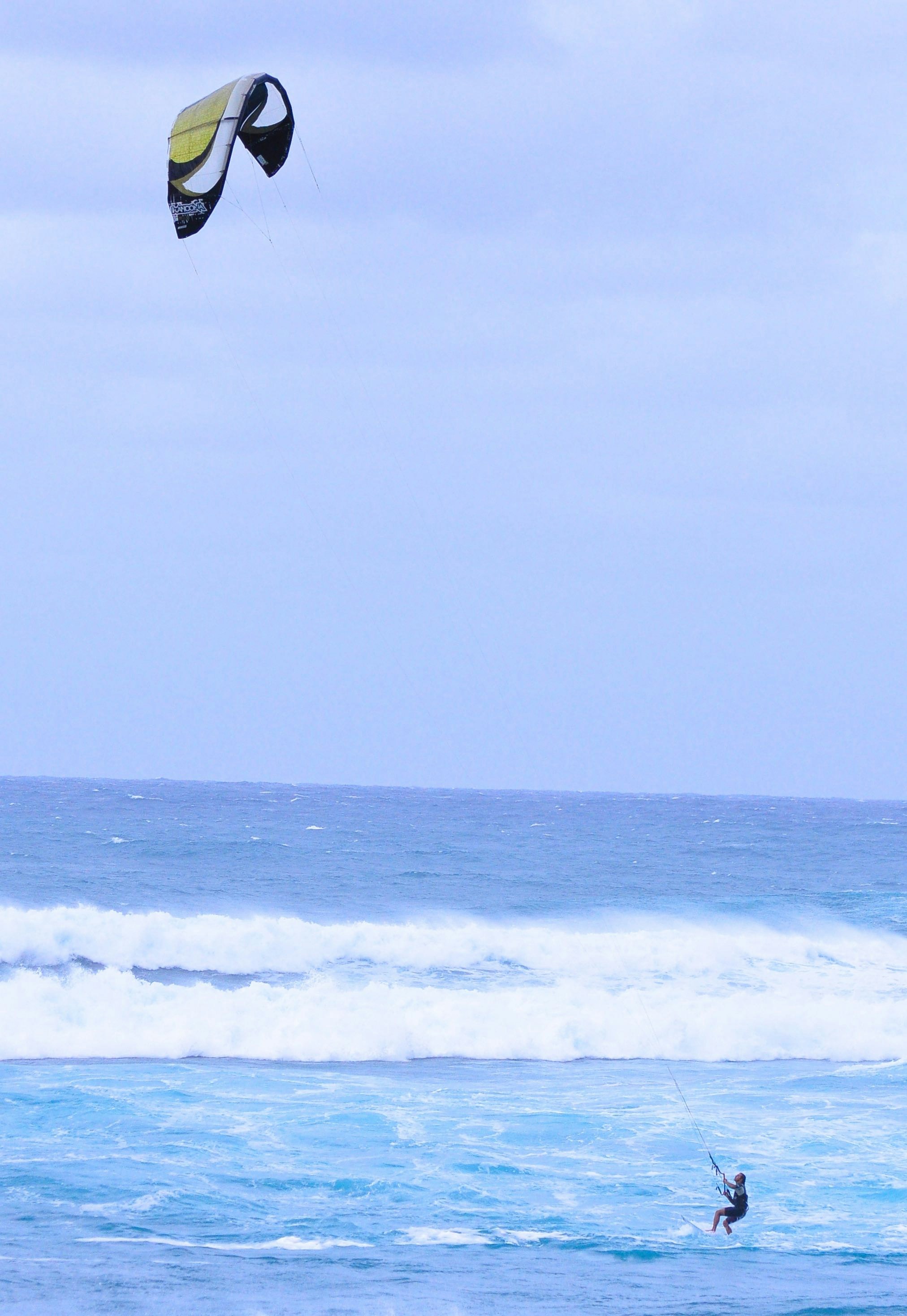 person surfing on sea waves during daytime