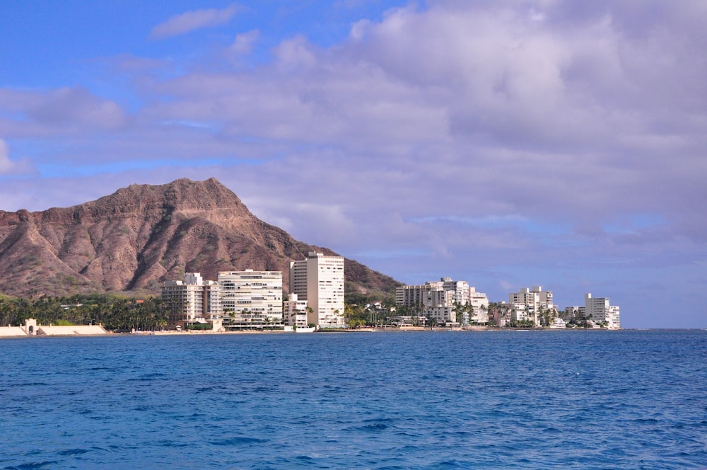 city buildings near body of water during daytime