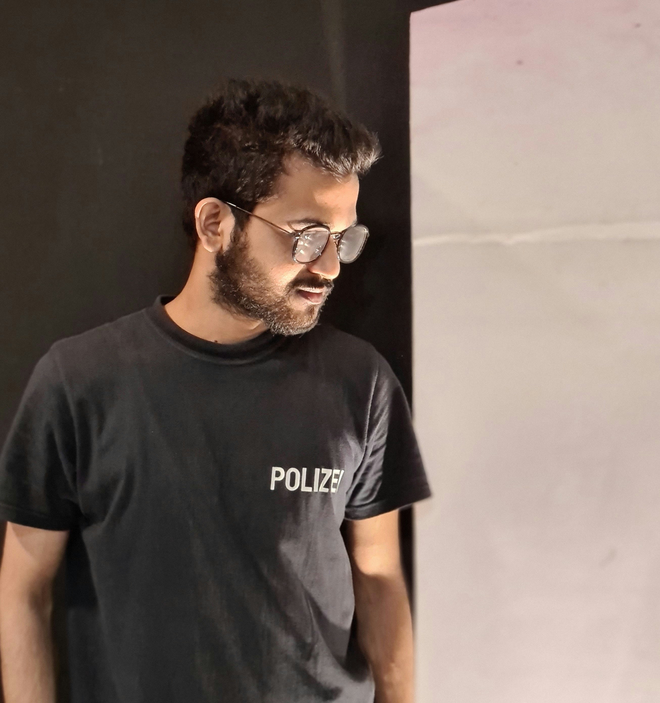 man in black crew neck t-shirt wearing black sunglasses