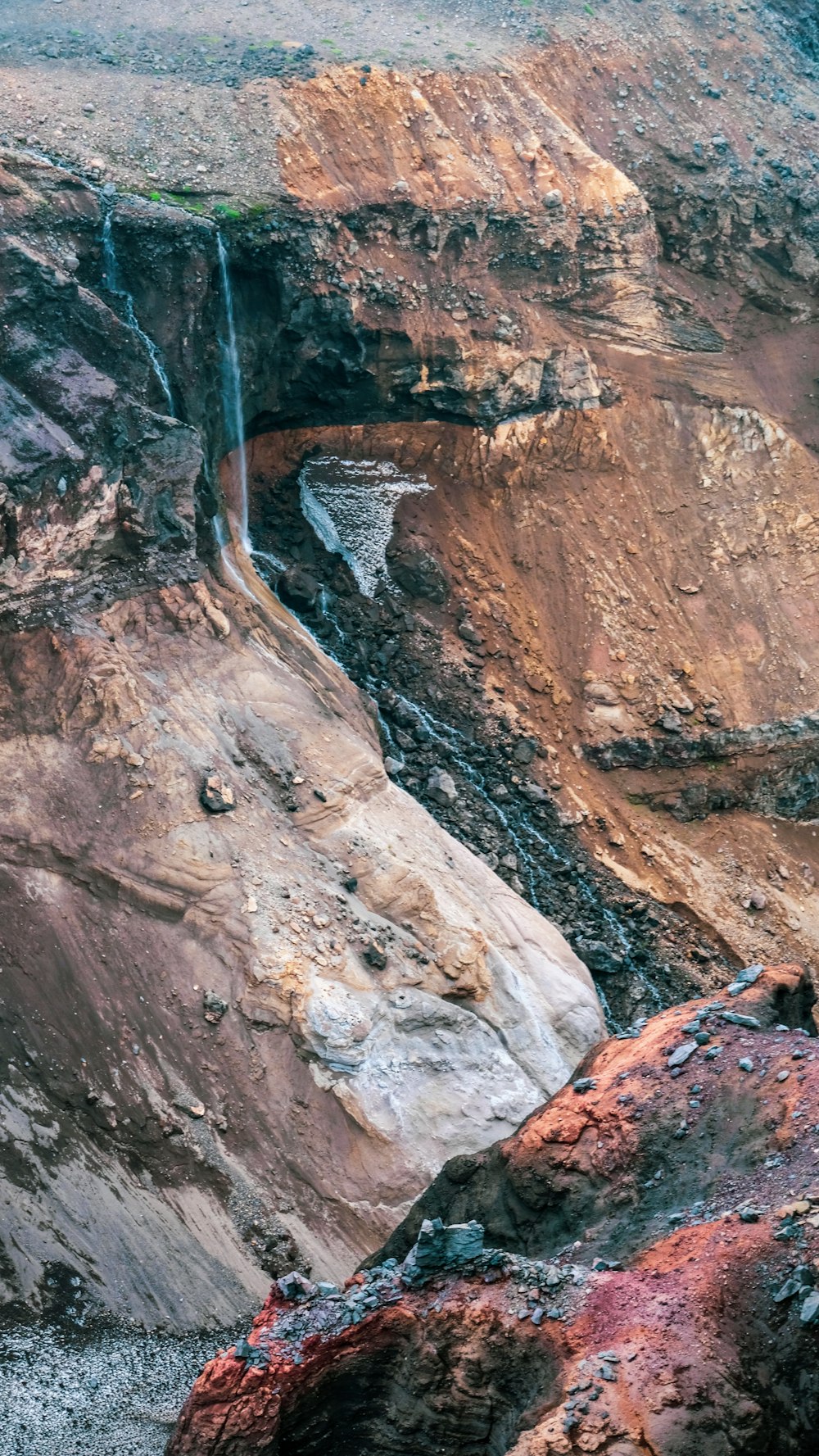 brown rocky mountain with river