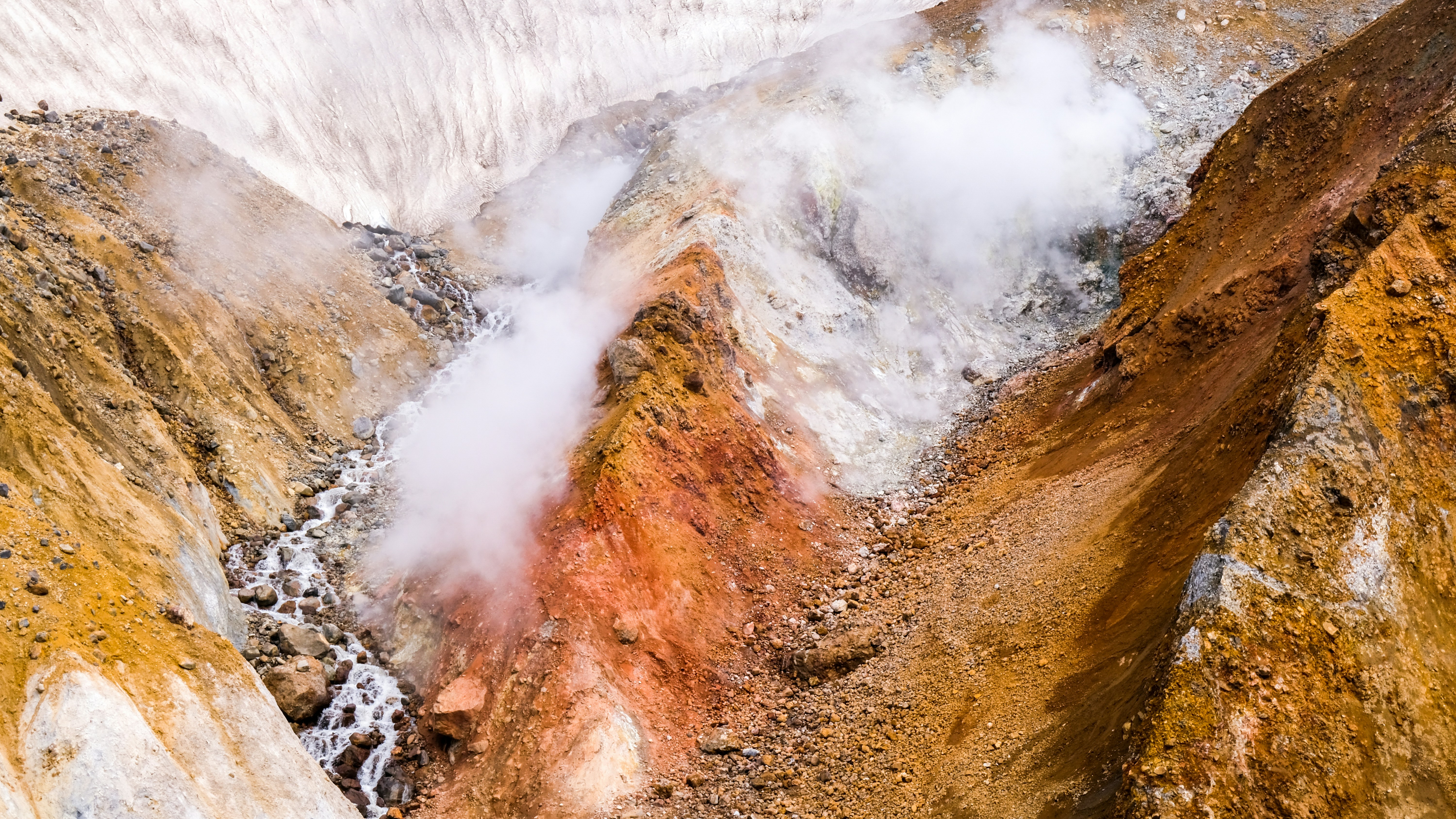brown and white mountain with white clouds