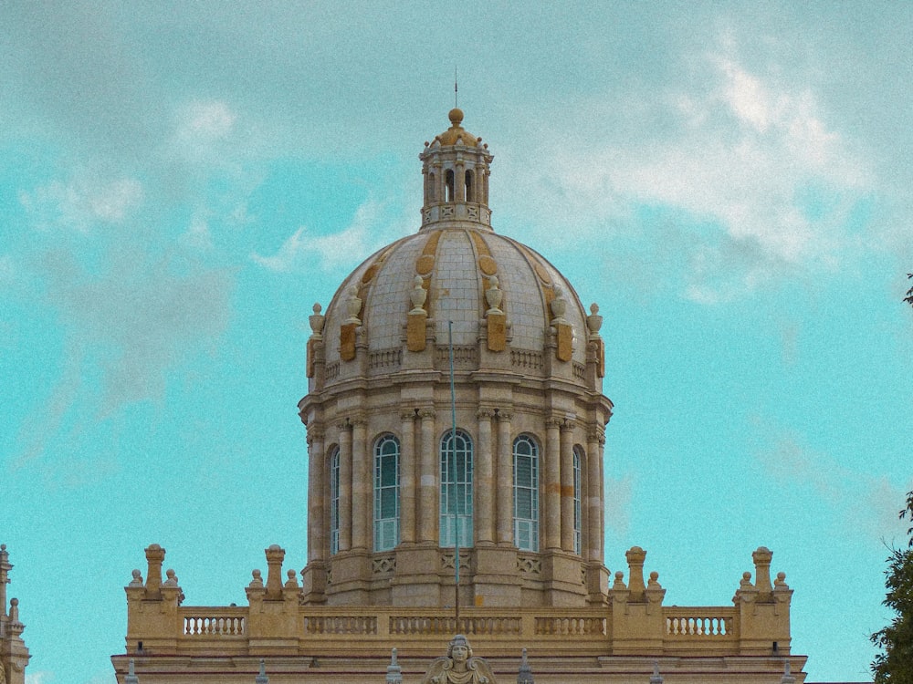 white concrete building under white clouds during daytime