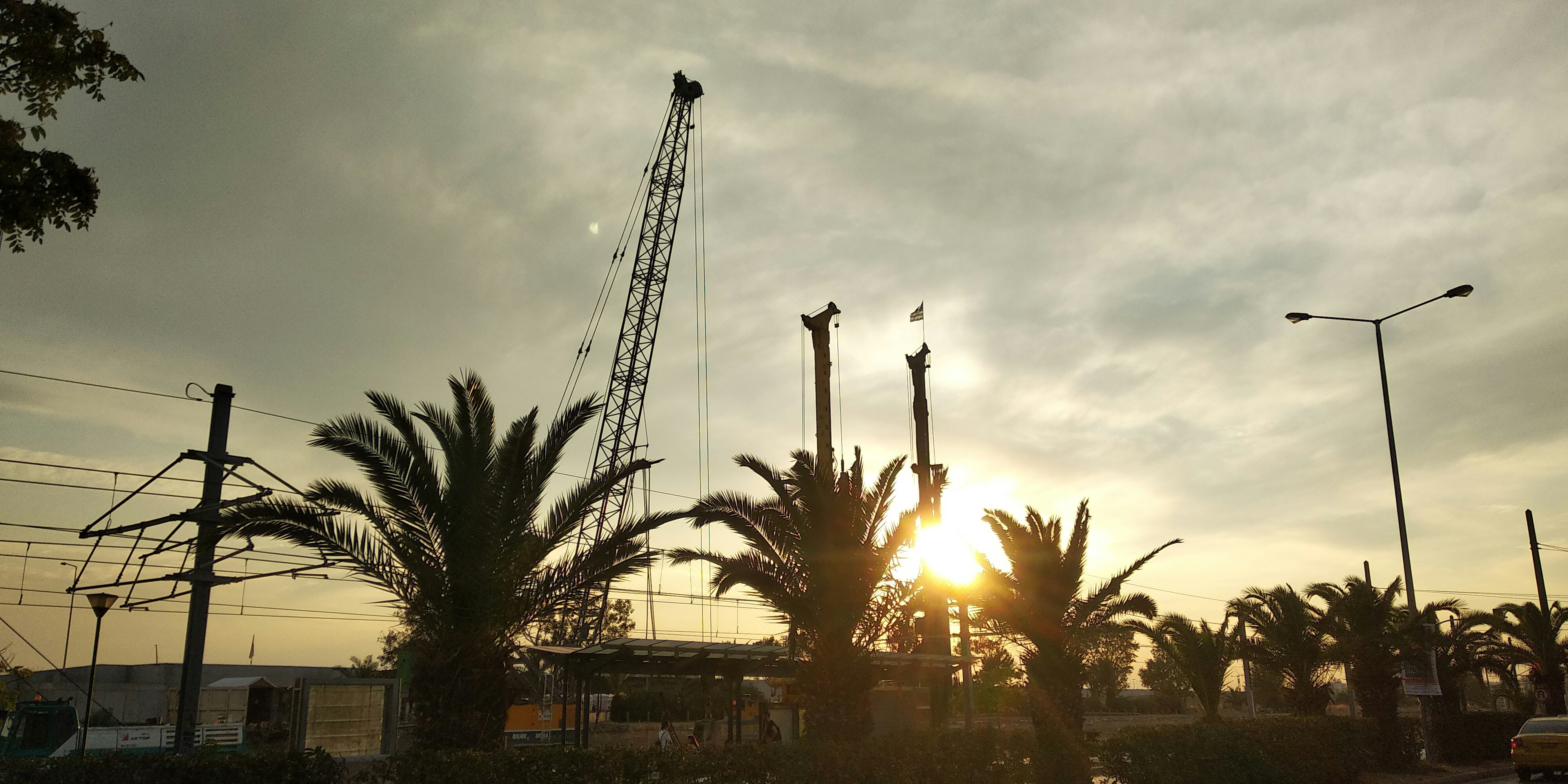 Green palm trees near building during sunset photo Free Kallithea