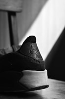 Close-up of a marfly id branded sneaker with dark tones and red accent lighting.