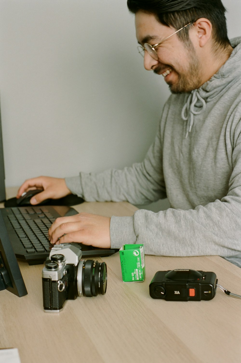 man in gray long sleeve shirt using black laptop computer