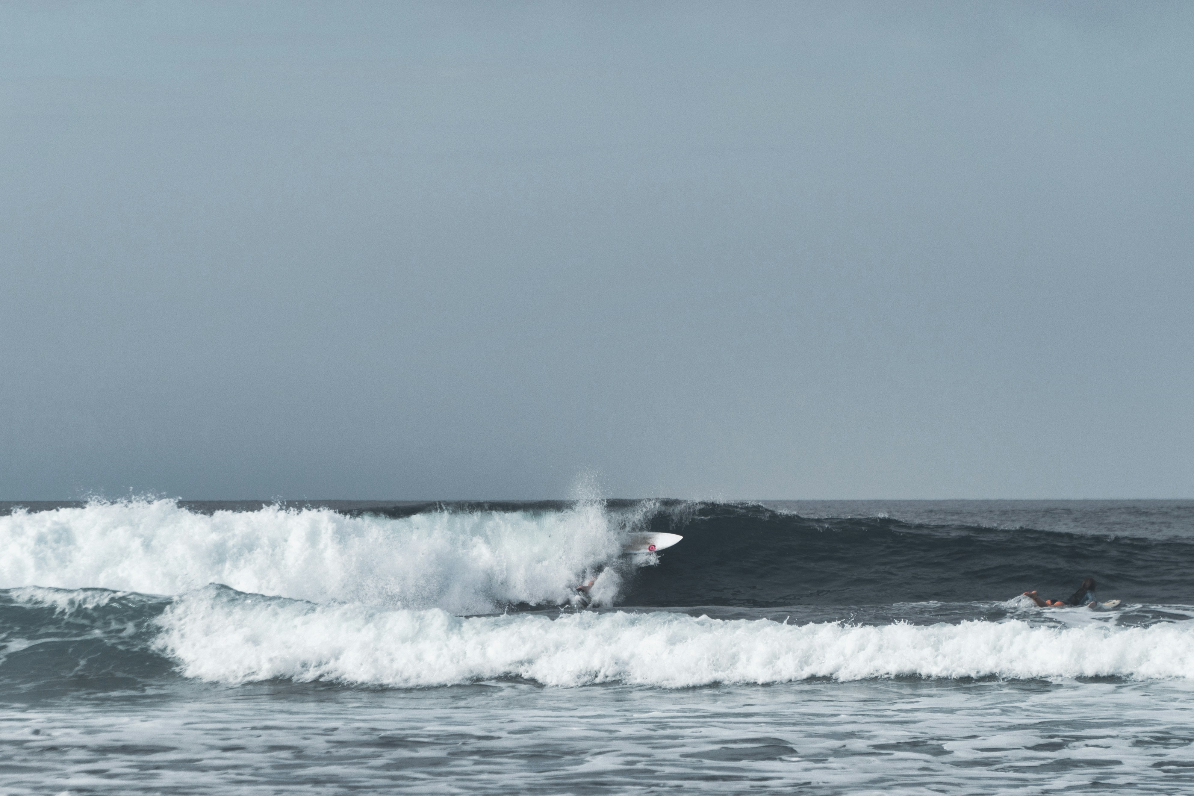 ocean waves under gray sky during daytime