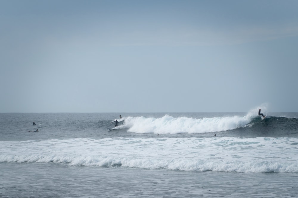 person surfing on sea waves during daytime