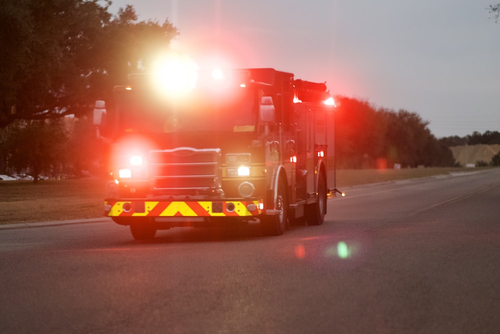 red and white fire truck on road during night time