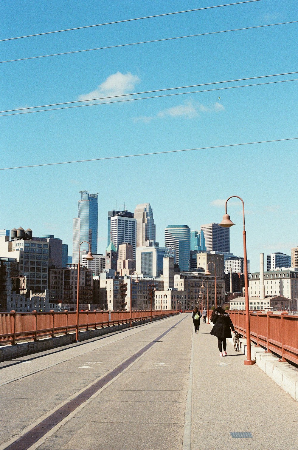people walking on sidewalk near city buildings during daytime