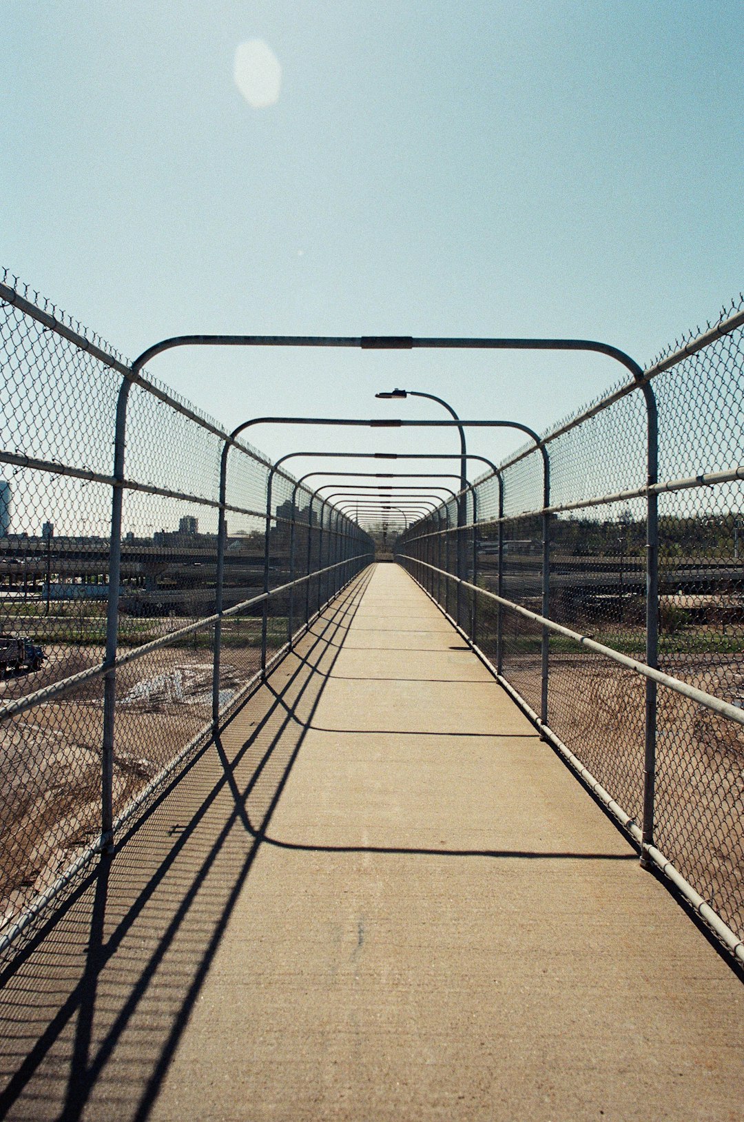 brown wooden bridge with white metal fence