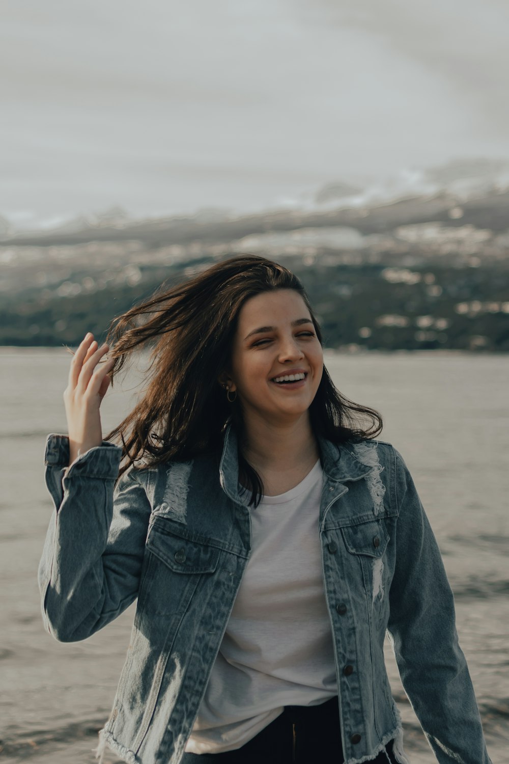 woman in blue denim jacket smiling