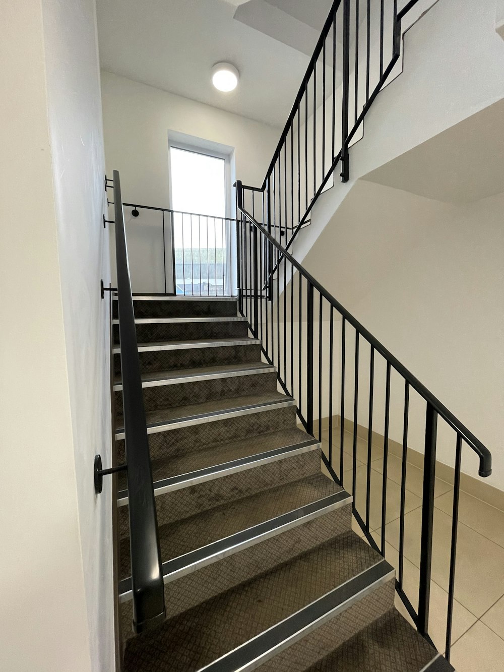 white staircase with black metal railings