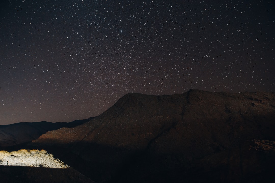 brown mountain under blue sky during night time