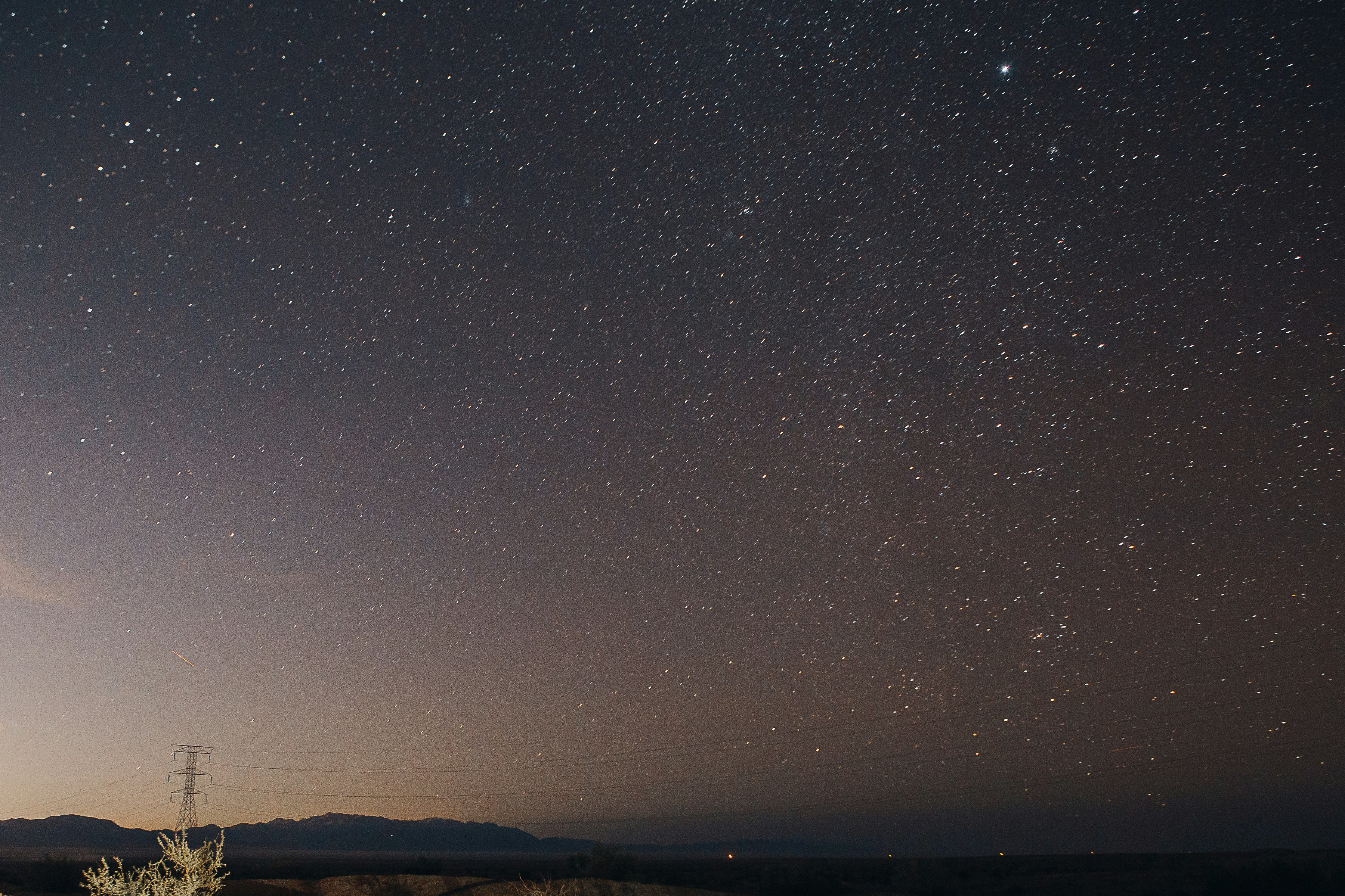 silhouette of mountain under starry night