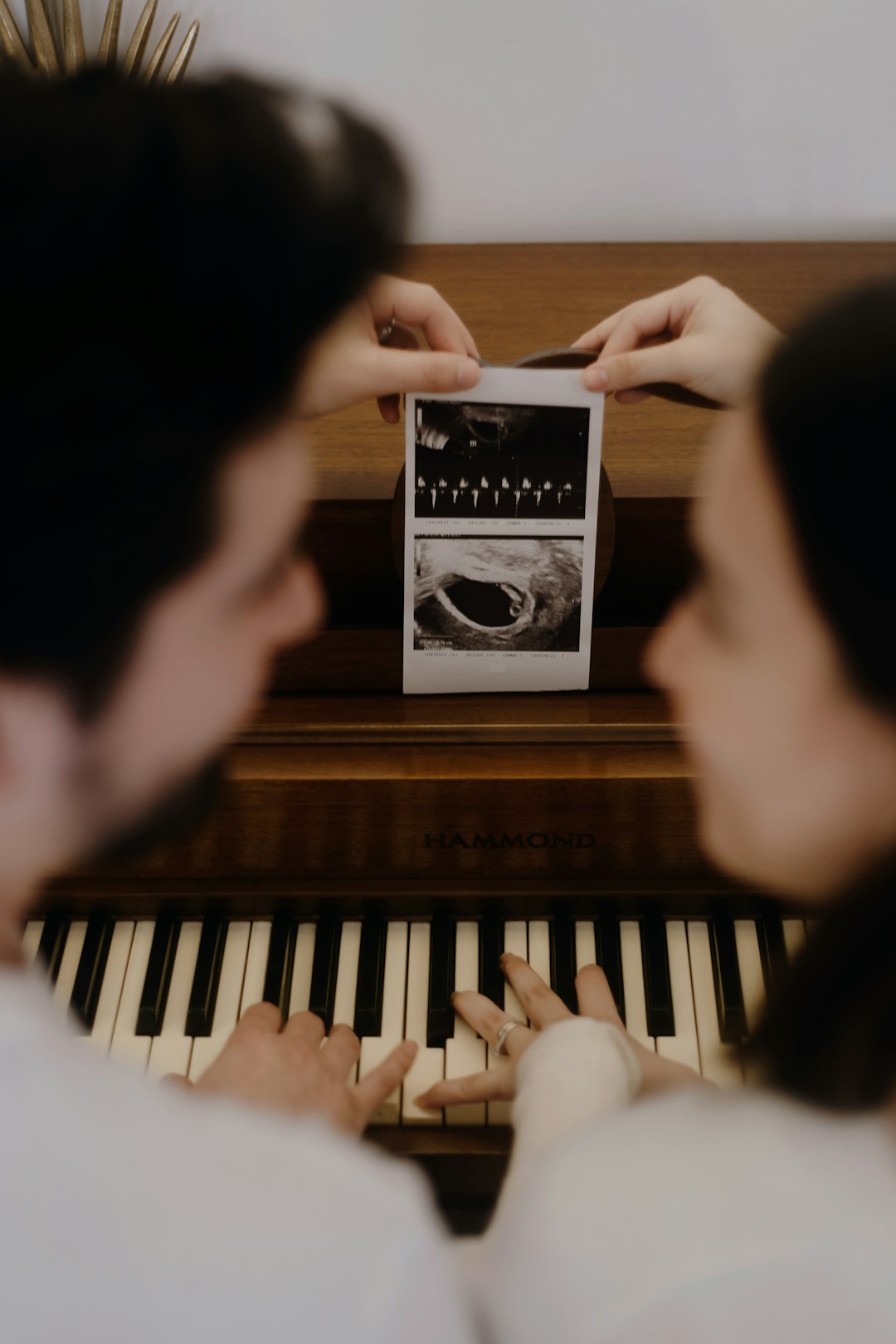person playing piano with black and white box