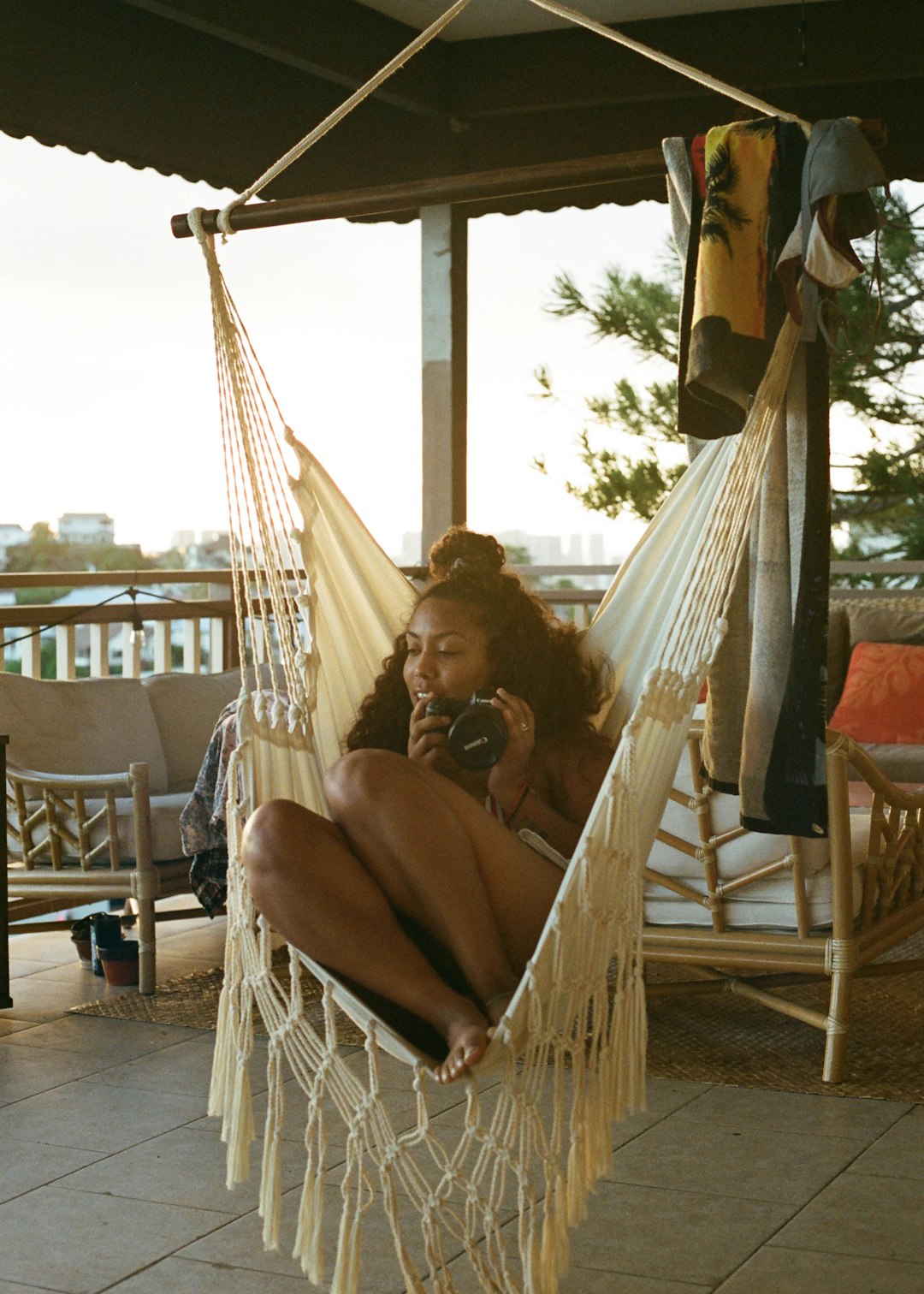 woman in black tank top sitting on white hammock