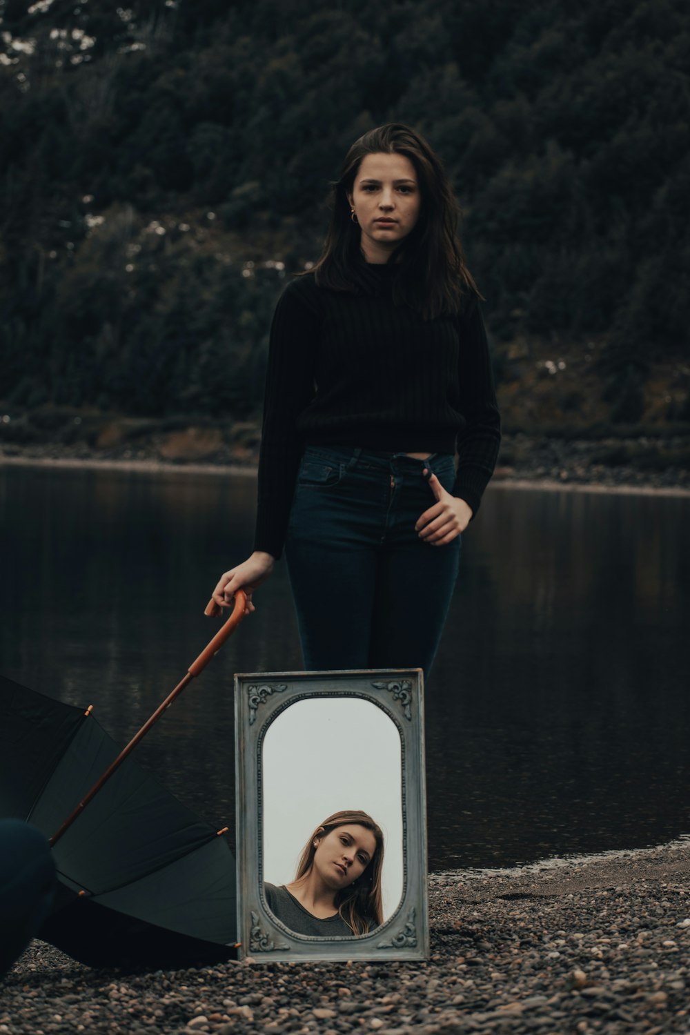 woman in black long sleeve shirt and blue denim jeans standing on boat during daytime