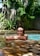 A satisfied customer standing next to their newly built pool.