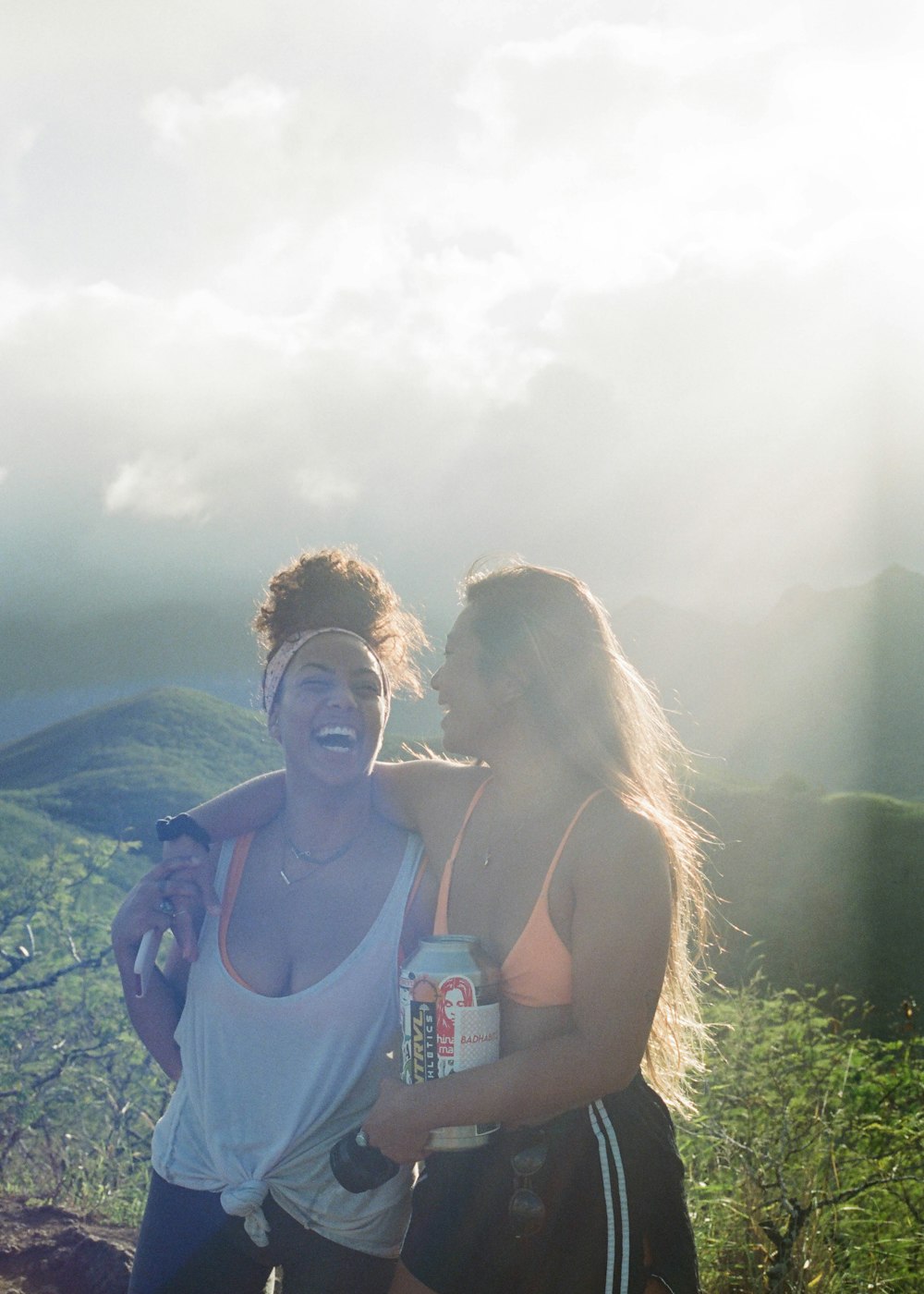 2 women sitting on rock formation during daytime