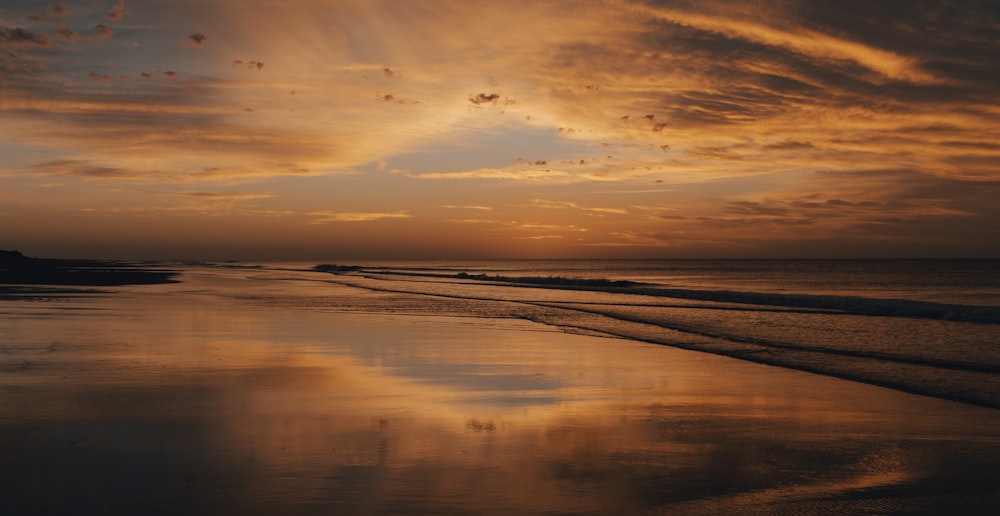 body of water during sunset